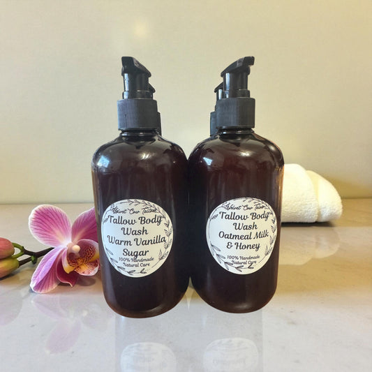 All-natural body wash bottles in warm vanilla sugar and oatmeal milk & honey scents with pink flower background.